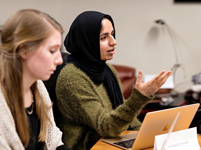 A student in a hijab speaks up during class